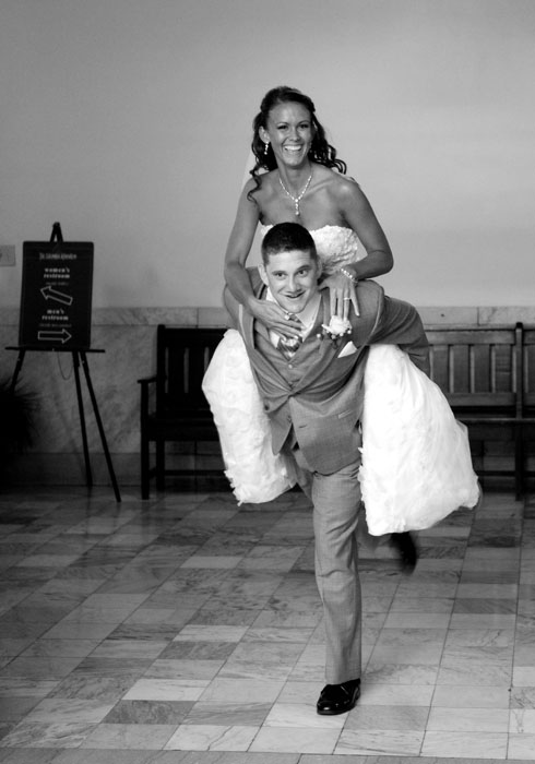 bride-and-groom-piggyback-ride-at-wedding-reception