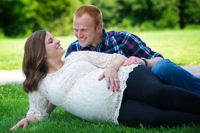 couple-laying-in-grass-for-maternity-photos