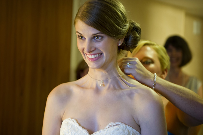 excited-bride-putting-on-necklase-before-wedding-at-renaissance-hotel