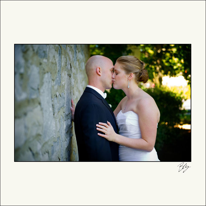 bride-and-groom-kissing-by-church-before-wedding-bly-photography