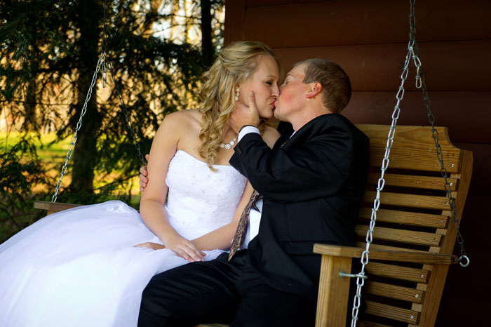 wedding-day-kiss-on-swing-at-ohio-cabin