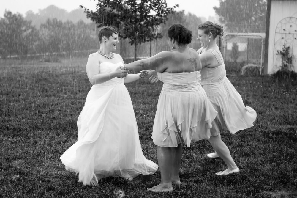 bride bridesmaids dancing in rain marysville oh bly photography