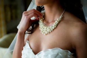 bride adjusting necklace bly photography