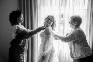 bride getting dressed window light