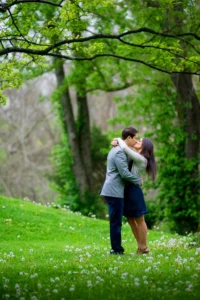 park of roses engagement kiss