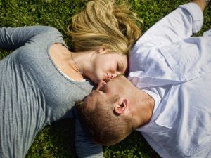 engagement-laying-on-grass-kissing-c66.jpg