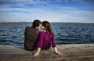 engagement-photographer-couple-kiss-on-dock-by-water-c67.jpg